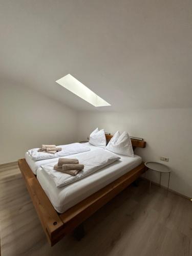 a bedroom with a bed with white sheets at Appartment Marcher in Kaprun