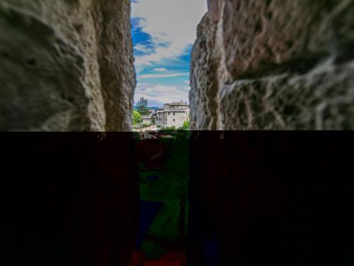 a view through a slit in a stone wall at Apartment La Torre-5 by Interhome in Stigliano