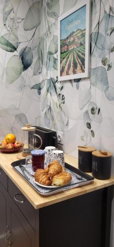 a tray of croissants on a counter in a kitchen at Charme et Nature, appartement cosy avec étang privé, au carrefour de 3 départements in Saint-Aigulin