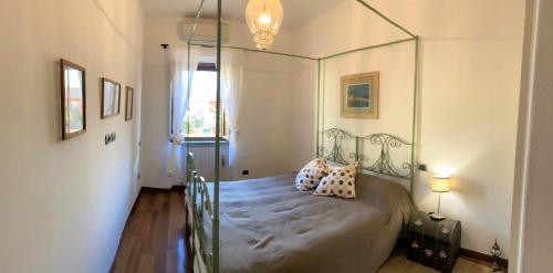 a bedroom with a canopy bed with pillows on it at Vistalaguna Orbetello in Orbetello