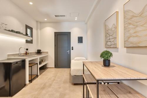 a kitchen and living room with a table and a sink at Marea Luxury Suites in Koríthion