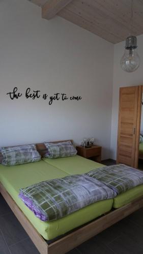 a bedroom with a bed with the words the best is yet to come at Apartment Inge in Rheinhausen
