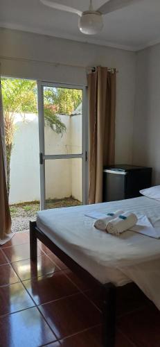 a bed in a room with two towels on it at Camping Pousada Ilha do Mel - Frente ao Mar in Boracéia