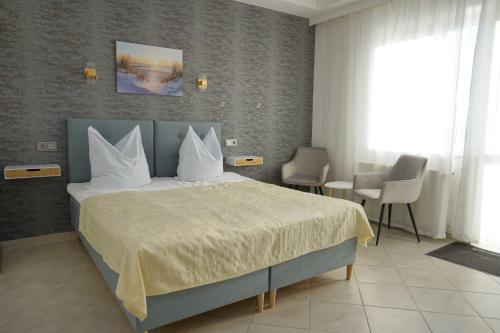a bedroom with a large bed with white pillows at Ferienappartement Teresa in Sławoszynko