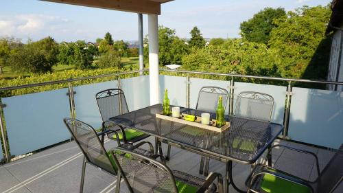 a table and chairs on a balcony with a view at Apartment Inge in Rheinhausen