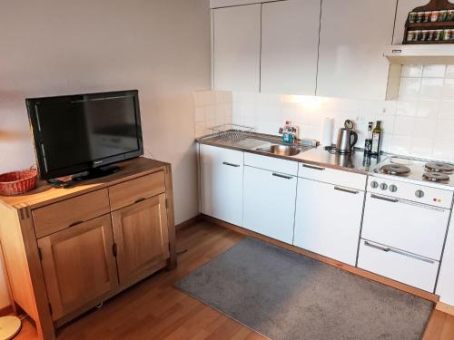 a kitchen with a sink and a tv on a counter at Apartment La Prada Wohnung 119 by Interhome in Laax