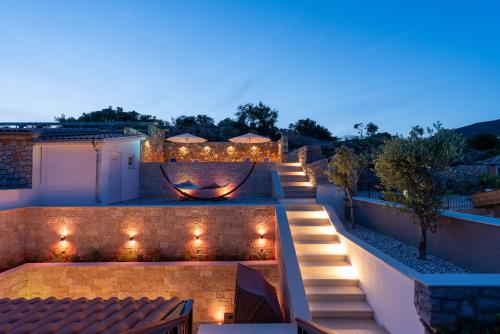 an outdoor patio with lights and a fire pit at Ferienhaus Sana in Klenovica