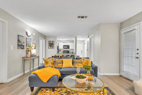 a living room with a blue couch and a table at Casa Marigold ATX - Cozy Stay - Near DT & Airport in Austin