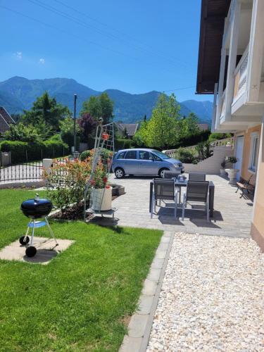 a patio with a grill and a car parked in a driveway at Ferienwohnung Karin in Sankt Jakob im Rosental