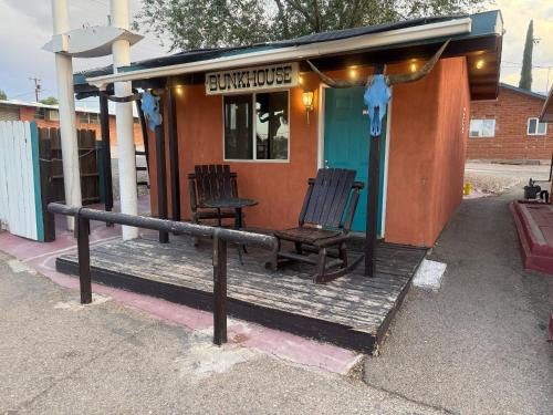 two chairs sitting on a porch of a building at Trail Riders Inn -Bunkhouse in Tombstone