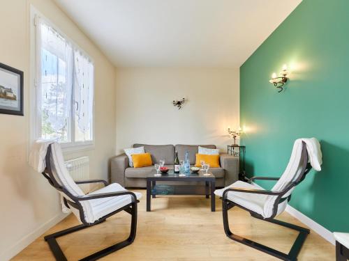 a living room with two chairs and a couch at Holiday Home Bellevue by Interhome in Denneville