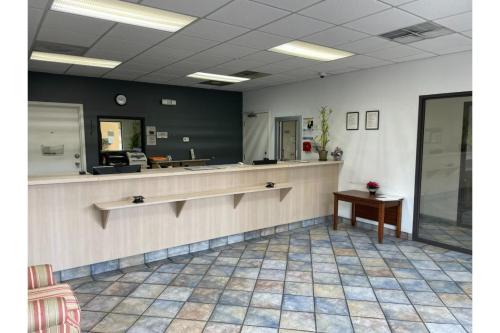 a waiting room with a counter and a table at Budget Inn Greenville By Hotel O I-85 in Greenville