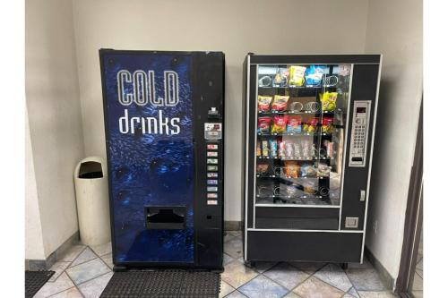 a soda vending machine with cold drinks in it at Budget Inn Greenville By Hotel O I-85 in Greenville