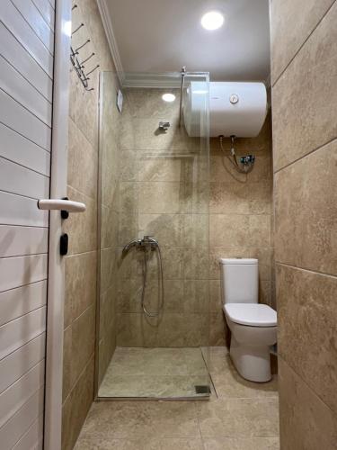 a bathroom with a shower and a toilet at Saranda View Apartments in Sarandë