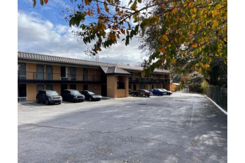 an empty parking lot in front of a hotel at Budget Inn Greenville By Hotel O I-85 in Greenville