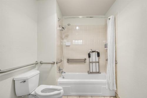 a white bathroom with a toilet and a shower at Best Western Gold Country Inn in Grass Valley