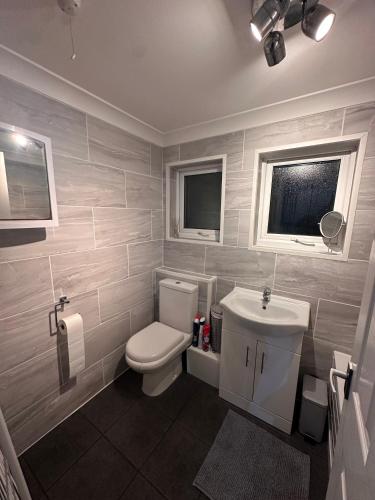 a bathroom with a toilet and a sink at 55 Florida Park Hemsby in Great Yarmouth