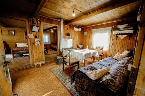 a room with a bed and a table in it at Stara brvnara Lubnice 
