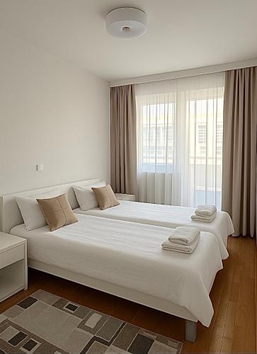 a bedroom with two large beds with towels on them at Harmony residence Ilidza in Sarajevo