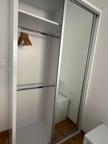 a walk in closet with a glass door at Harmony residence Ilidza in Sarajevo