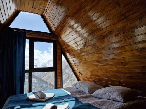 a bedroom with a large window and a bed in a room at Cottage Hillside in Juta in Jut'a