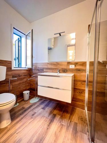 a bathroom with a sink and a toilet at Le Case di Ciccine' in Bagheria