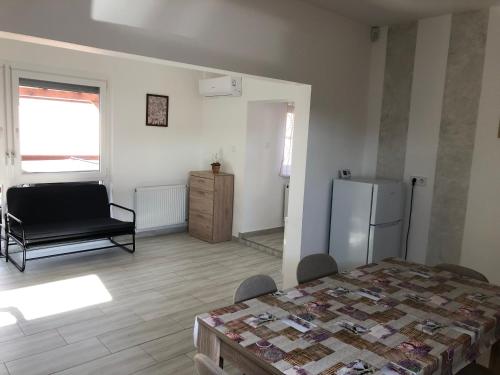 a room with a bed and a refrigerator in it at Mini Zoo Rezidencia in Nagykanizsa