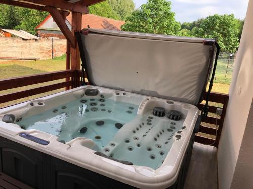 a jacuzzi tub on the back of a porch at Mini Zoo Rezidencia in Nagykanizsa
