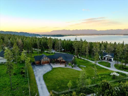 an aerial view of a home with a lake at Luxe Lakeside New Build by Flathead Lake Speakeasy in Somers