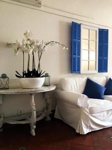 a living room with a couch and a table with flowers at Sunbay Park Hotel in Civitavecchia