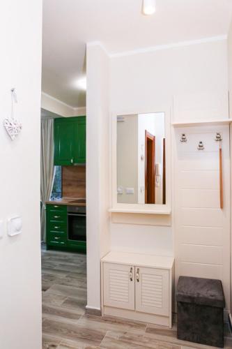 a kitchen with green cabinets and a mirror at Adria Mare one bedroom apartment in Tušupi