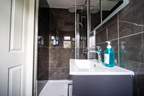 a bathroom with a sink and a shower at Pleasant Studio in St Albans in Saint Albans