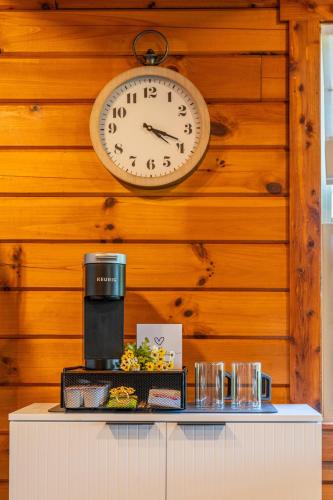 a clock on a wooden wall above a counter at Sage Brush Cabin in Millersburg
