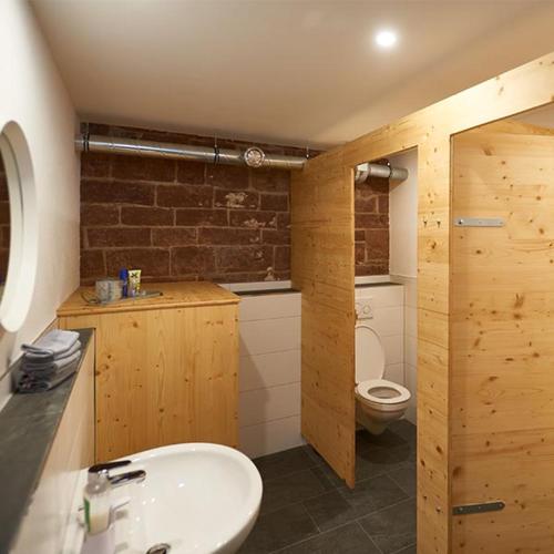 a bathroom with a white sink and a toilet at Bauwagen Villa Sweden in Rauenberg