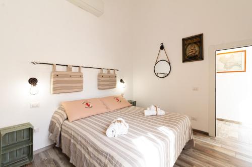a bedroom with a bed with hello kitty pillows on it at Beb Diavolo Furbetto in Orco Feglino