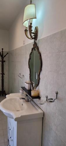 a bathroom with a sink and a mirror on the wall at Casa San Rocco in Bolsena