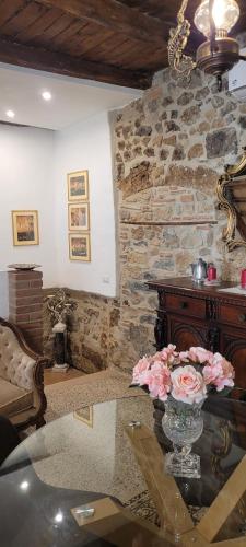 a living room with a vase of flowers on a table at Casa San Rocco in Bolsena