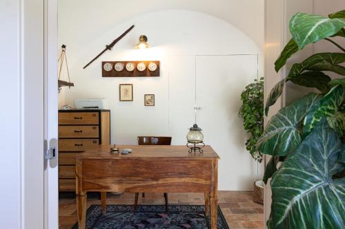 a room with a wooden table and a dresser at Beb Diavolo Furbetto in Orco Feglino
