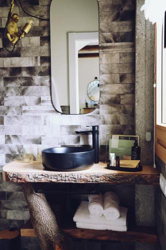 a bathroom with a sink and a mirror and towels at Villaverde Village in Santillana del Mar