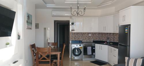 a kitchen with a washer and dryer in it at Sharm hills sea view in Sharm El Sheikh