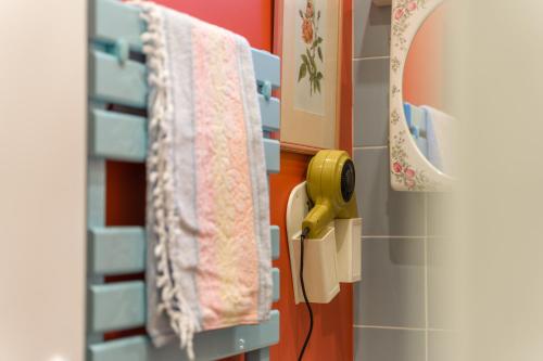 a bathroom with pink towels hanging on a rack at Les Seventies - Confort Vintage proche gare in Chambéry