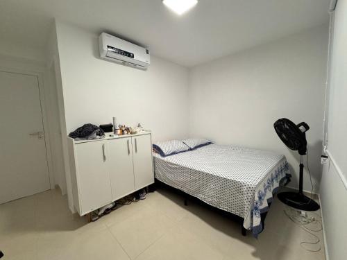 a small bedroom with a bed and a air conditioner at Aruana - Diamante in Aracaju