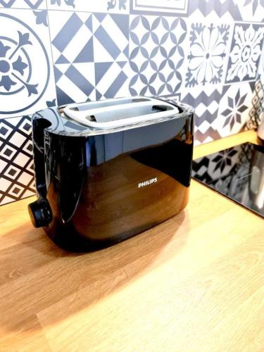 a toaster sitting on top of a wooden table at L'Europa - Gare - Centre - Wifi in Arras