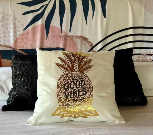 a pineapple pillow sitting on top of a bed at Hotel Tranquilo in Las Peñitas
