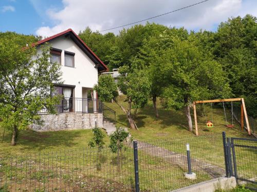 a house with a yard with a playground at Kuća za odmor IVA in Stajnica