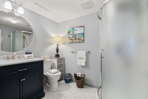 a bathroom with a toilet and a sink and a mirror at Waterfront Incredible Views and Private Dock in Yarmouth