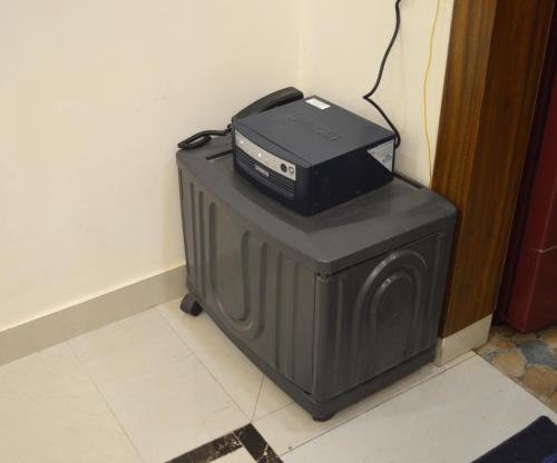 a computer printer on top of a box at Ananta Square - Rishikesh 1BHK in Rishīkesh