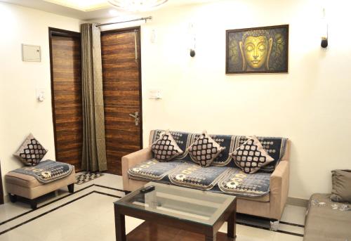 a living room with a couch and a table at Ananta Square - Rishikesh 1BHK in Rishīkesh