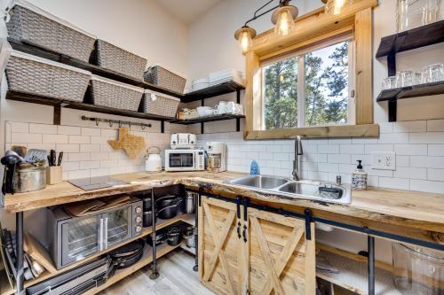 a kitchen with a sink and a microwave at 13 Mi to USAFA Peaceful Colorado Springs Getaway! in Gleneagle