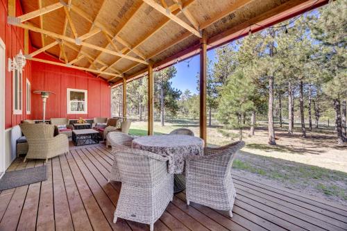 a patio with a table and chairs on a deck at 13 Mi to USAFA Peaceful Colorado Springs Getaway! in Gleneagle